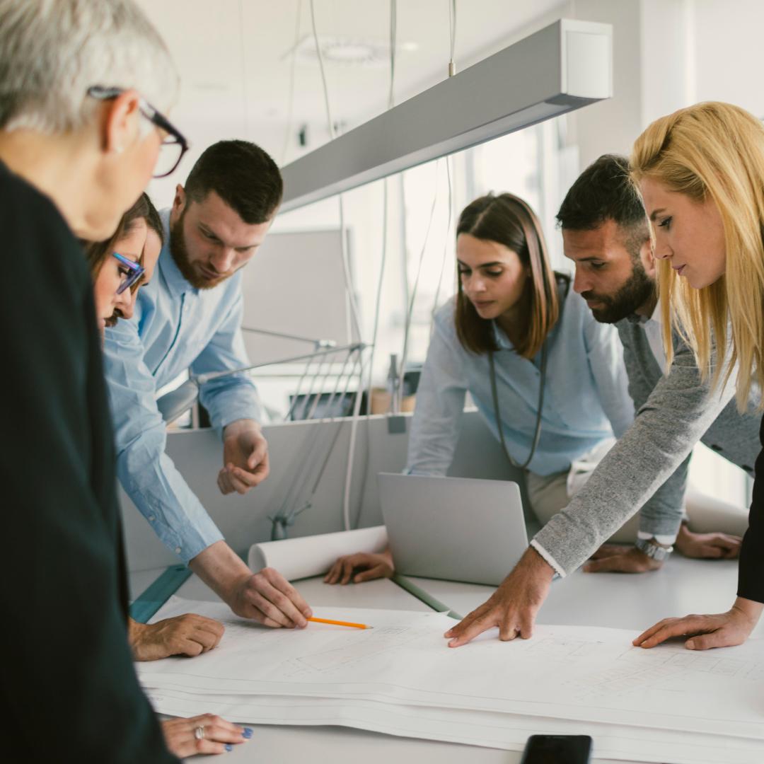 Architect Wiki: several architects stand around the table and plan a project